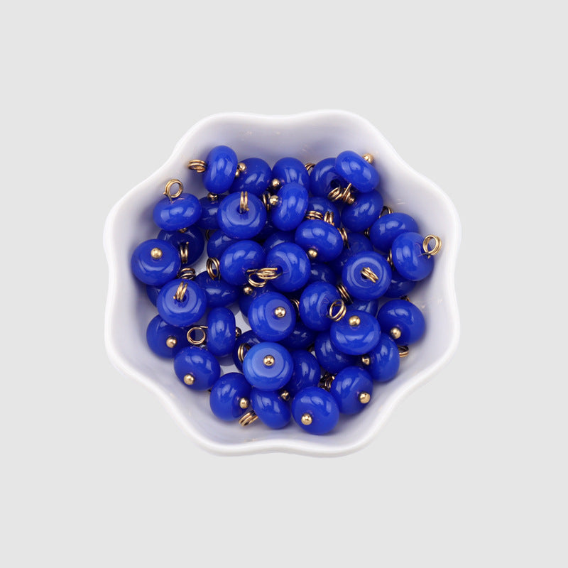 Royal-blue 10mm resin buttons, round domed faces with gold shanks (multiple in bowl)