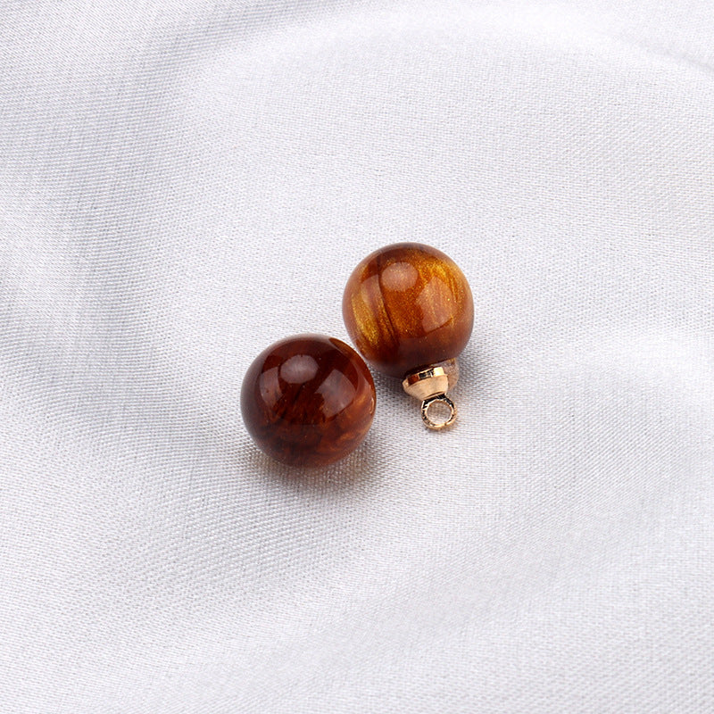 Dark brown resin bead buttons with gold shank loops (pair close-up)