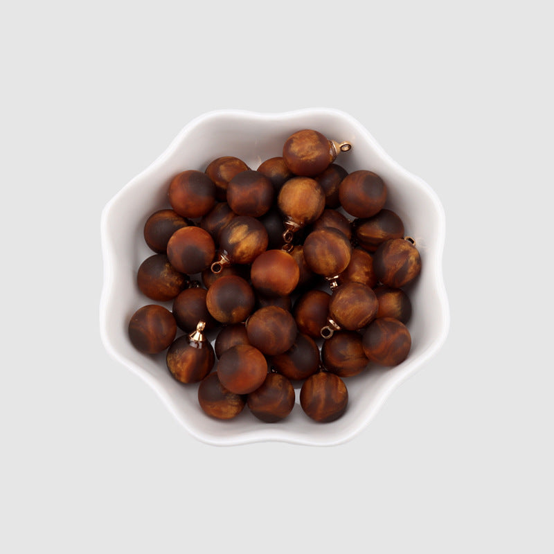 Brown resin bead buttons, round beads with gold shank loops (bulk view)