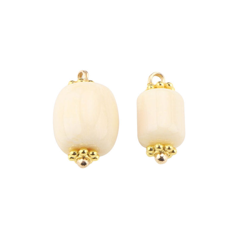Beige resin frog button with gold top loop and textured gold stud detail