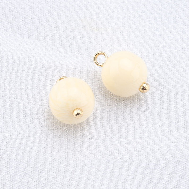 Beige round resin frog button pair with gold loop and gold dome stud