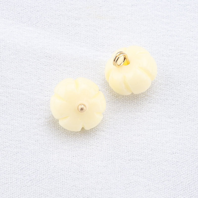 Beige flower-cap resin frog buttons with gold loop and small gold center stud