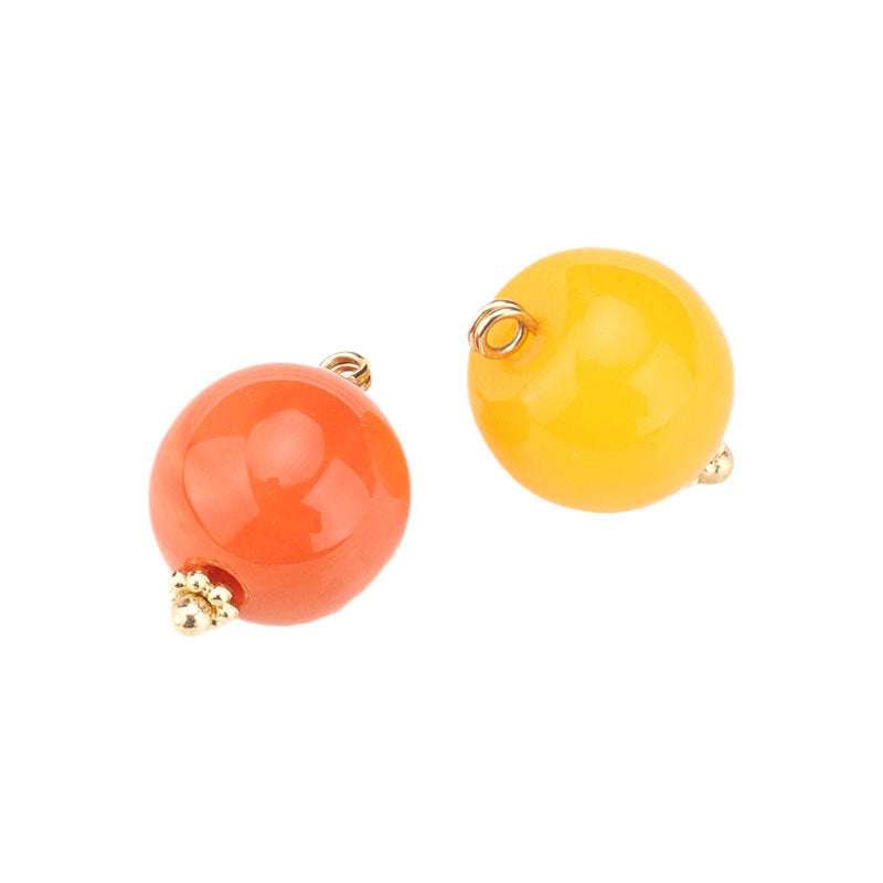 Orange resin bead buttons with flower base, gold-tone loops and small crystal details