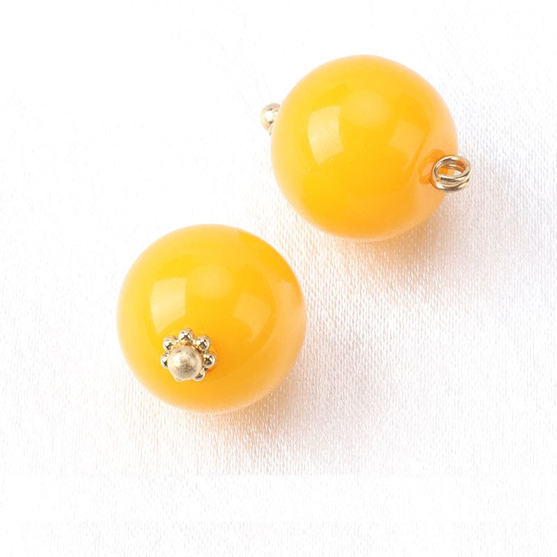 Yellow resin bead buttons with flower base, gold-tone loop backs