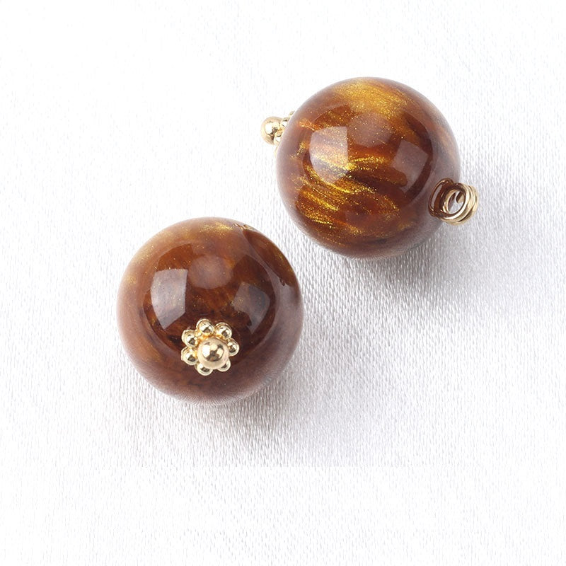 Amber/brown resin bead buttons with flower base, gold-tone loop backs