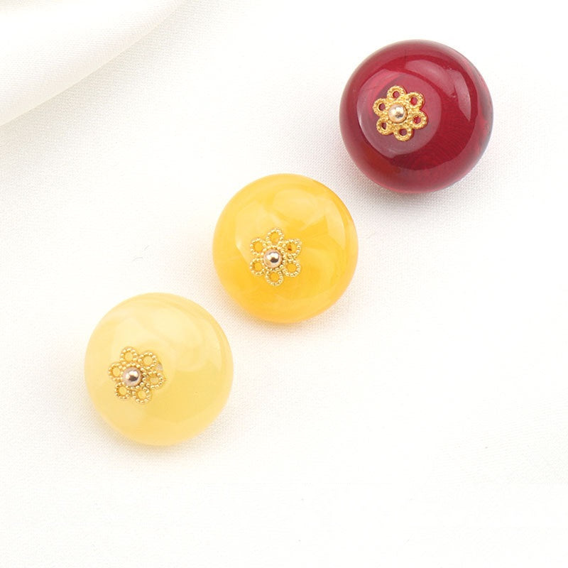 Round resin buttons: two yellow and one dark red, gold floral stud centers, 15mm