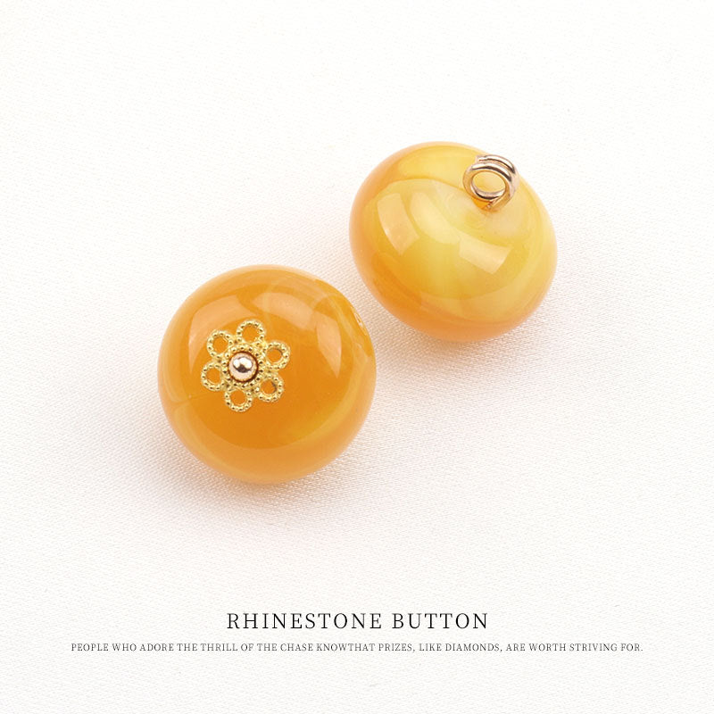 Round resin frog buttons in yellow and amber with gold floral rhinestone design and loop