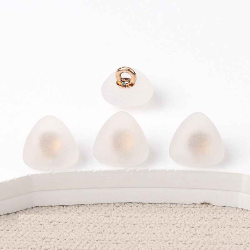 Triangular matte resin shank buttons, off-white fronts with gold-tone loop shank