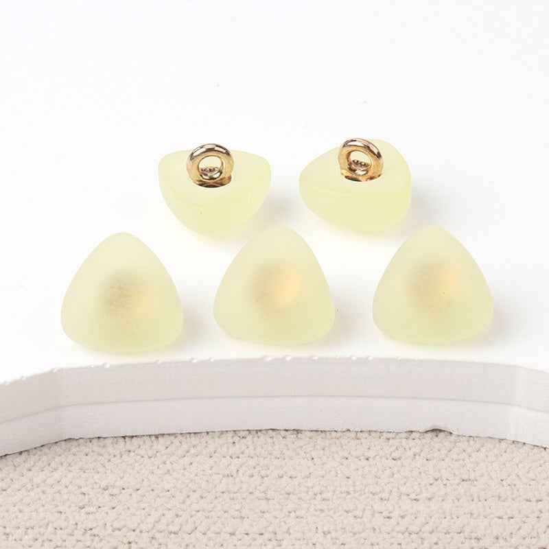Triangular matte resin shank buttons, pale yellow fronts with gold-tone loop shank