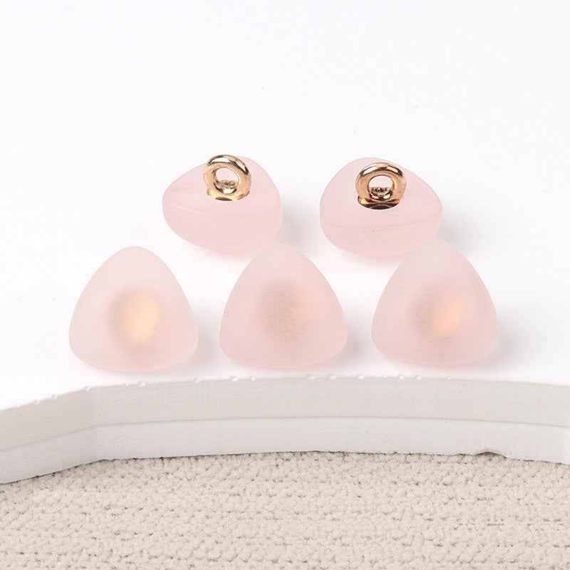 Triangular matte resin shank buttons, light pink fronts with gold-tone loop shank