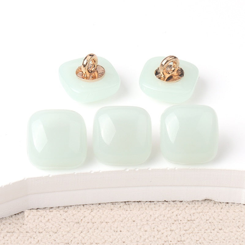 Light mint square resin buttons with visible gold-tone metal loops