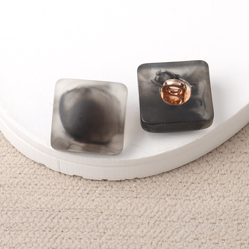 Gray and black resin square shank buttons with metal loop, pair view