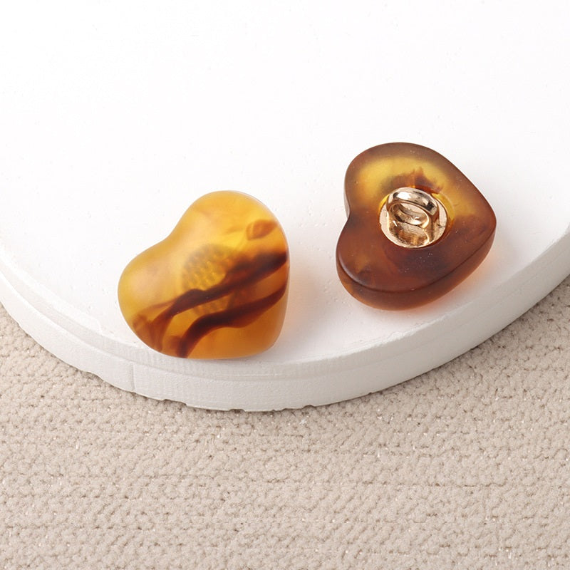 Amber resin heart-shaped shank buttons with metal loop, pair view