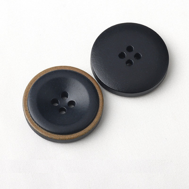Pair of dark four-hole coat buttons with burnt edge detail