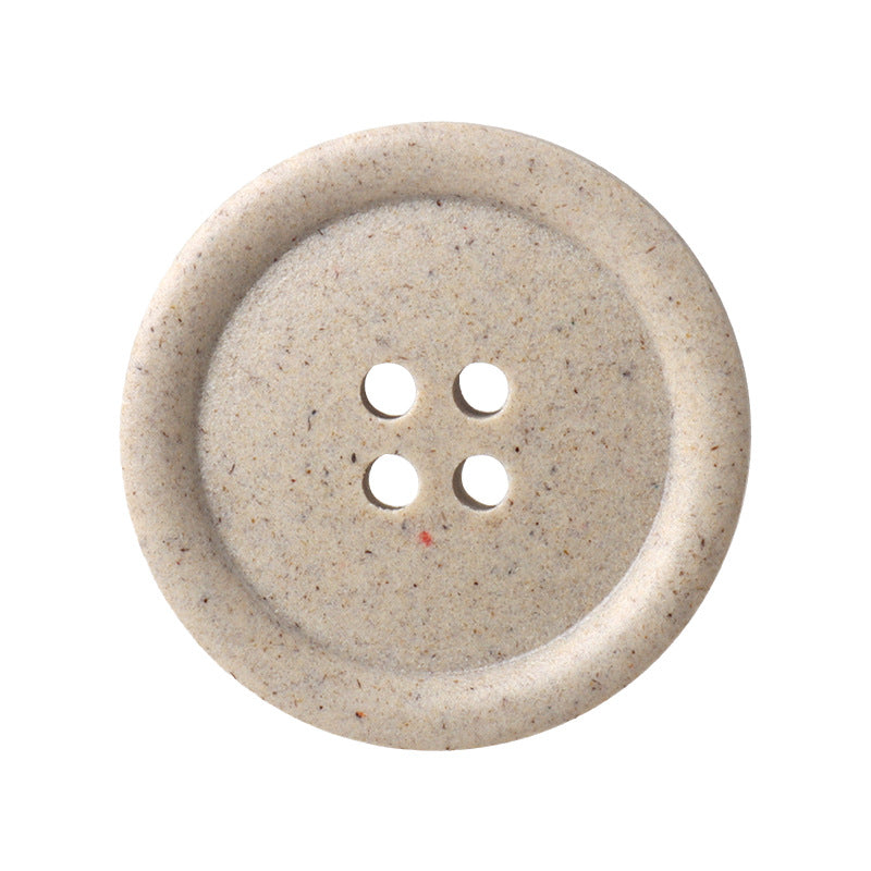 Round four-hole buttons, frosted beige resin, close-up of button face