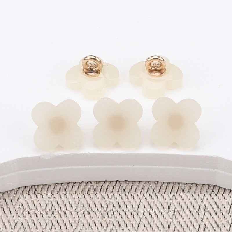 Flower-shaped resin buttons with high shank, ivory/cream front, gold-tone base