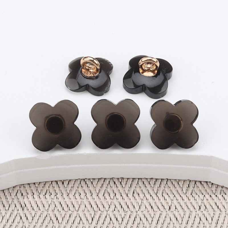 Set of flower-shaped resin buttons with high shanks, dark (brown/black) faces