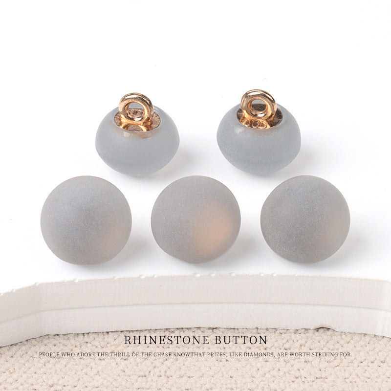 Round matte resin buttons in soft gray tones with metal shank—small set.