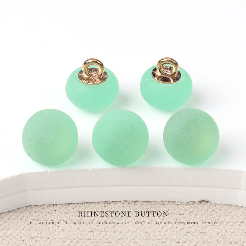 Round matte resin buttons in mint green with metal shank—small round design.