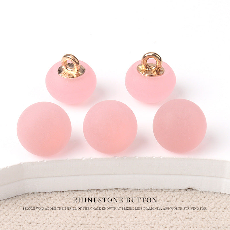 Round matte resin buttons in pastel pink with metal shank—small round buttons.