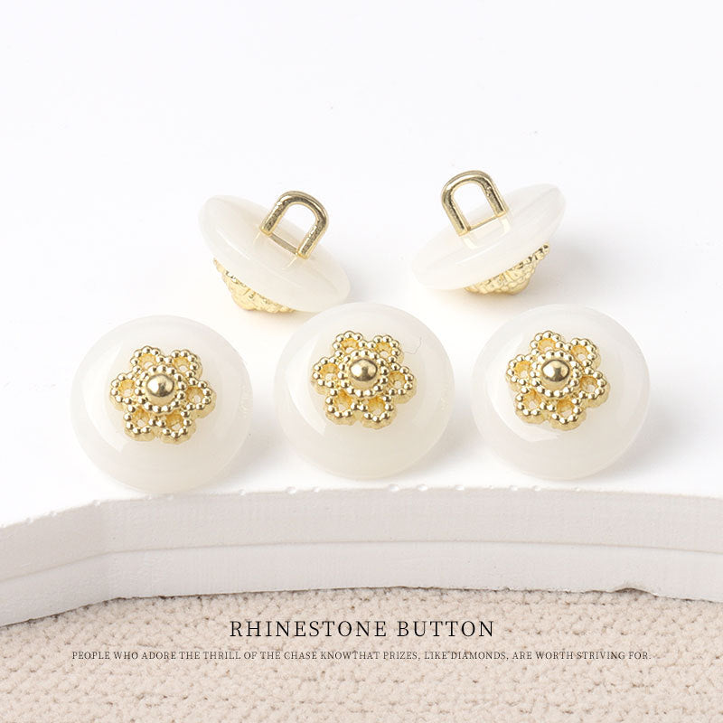 Round resin shank buttons, white finish with gold floral rhinestone centers, shank backs shown