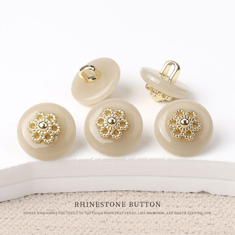 Round resin shank buttons with gold floral rhinestone centers in ivory, yellow, and cream tones