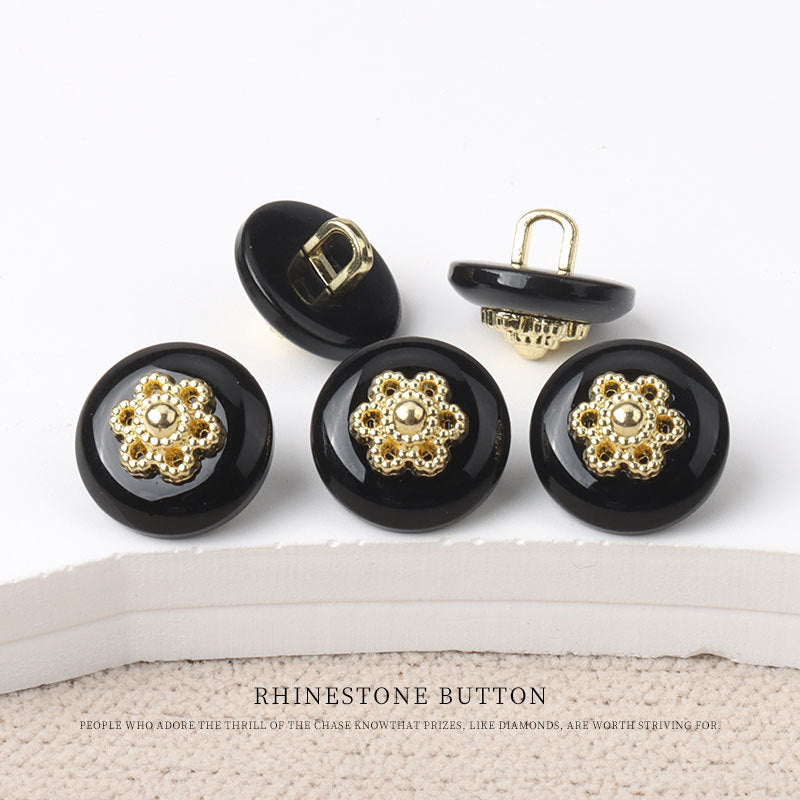 Round resin shank buttons, black finish with gold floral rhinestone centers, shank backs shown