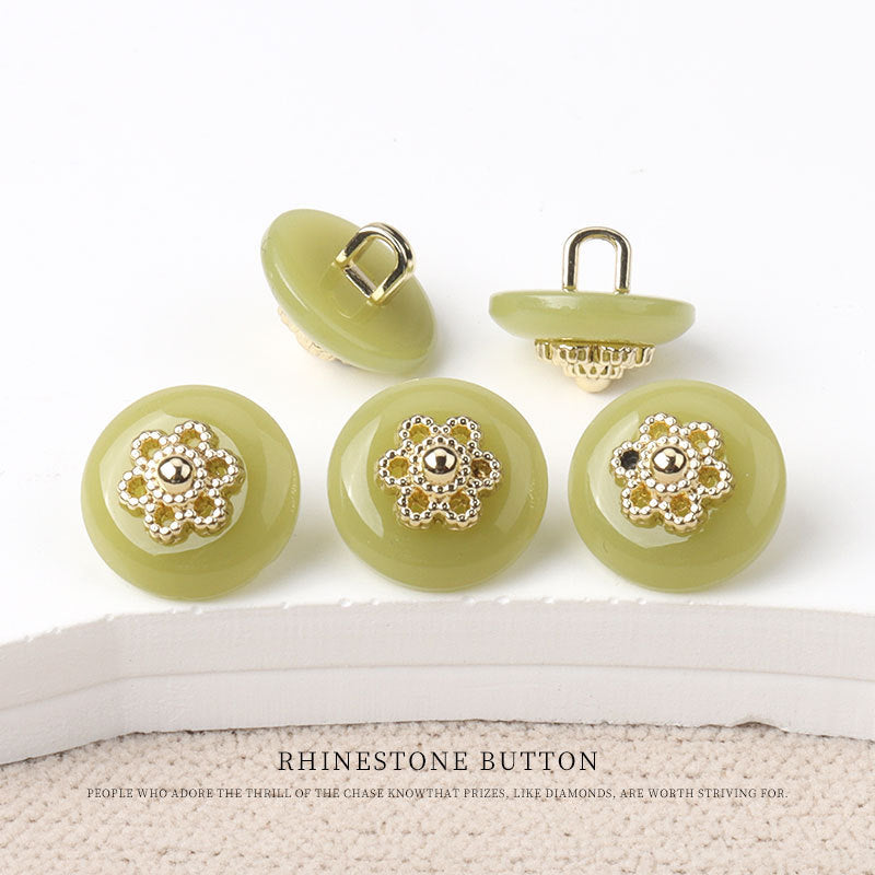 Round resin shank buttons, light green finish with gold floral rhinestone centers, shank backs shown
