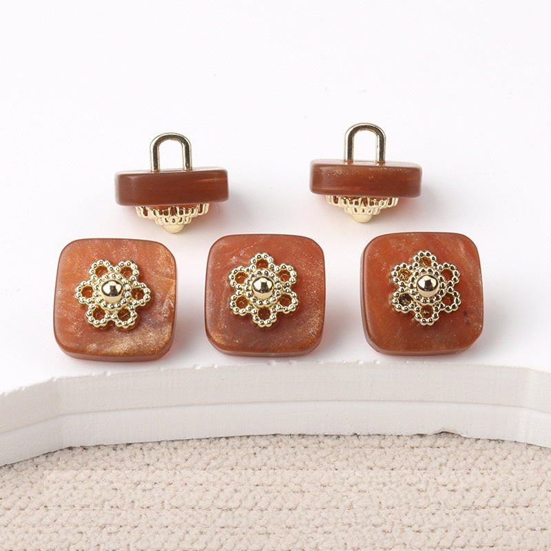 Square resin buttons with metal shanks, ornate silver center; brown.