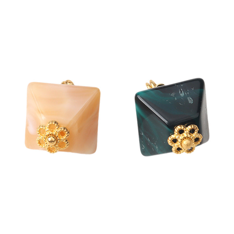 Pair of square translucent acrylic buttons with gold rhinestone flower embellishment, peach and dark teal.