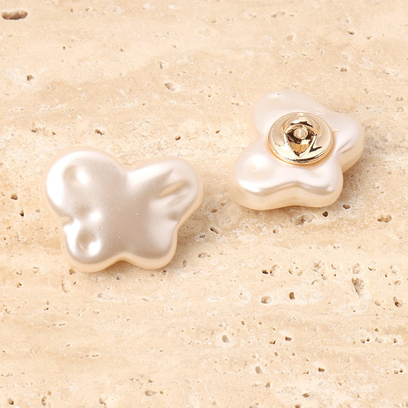 Pearl white resin butterfly sewing buttons with metal shanks, front metal base