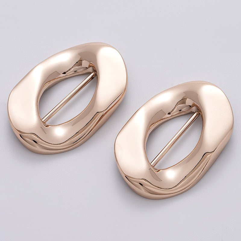 Two-piece irregular rose-gold buckle set with rectangular pin bar, side-by-side
