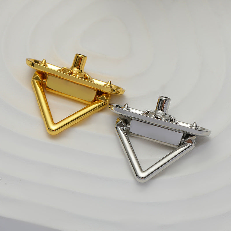 Triangular snap metal buttons, gold and silver, showing front and back sides