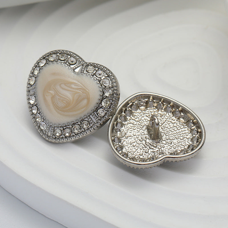 Heart-shaped metal buttons: white oiled front and shiny backs with metal pin