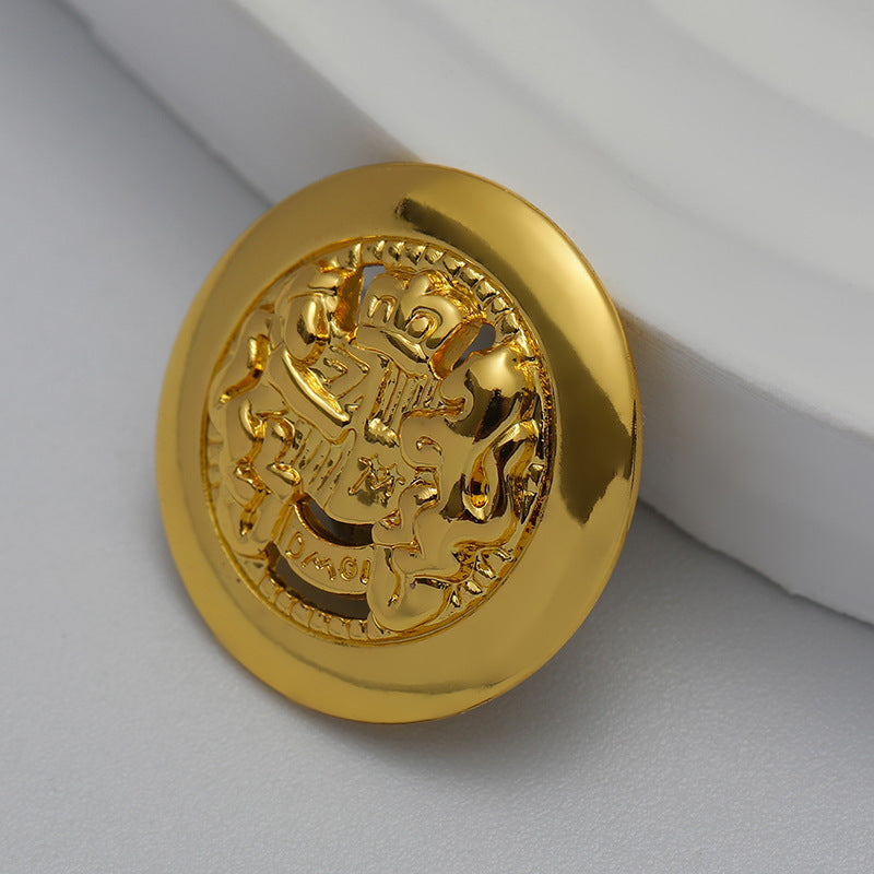 Gold lion crest hollow metal button, close-up of detailed relief border