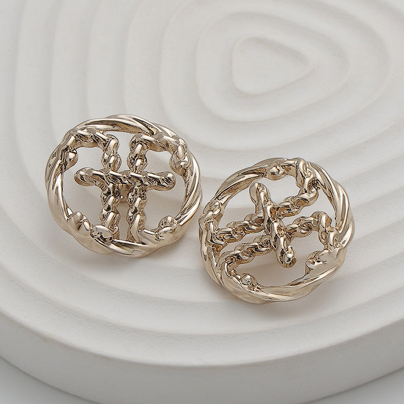 Pair of light gold hollow metal double E buttons, ornate openwork front detail