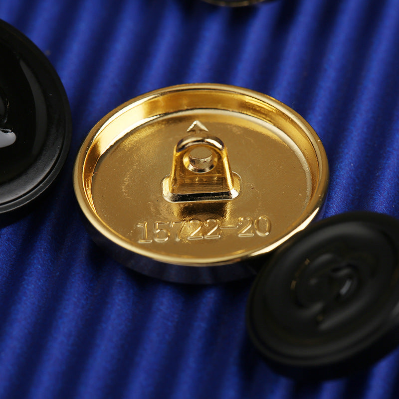 Back of gold-tone zinc alloy button with mounting loop and stamped 16722