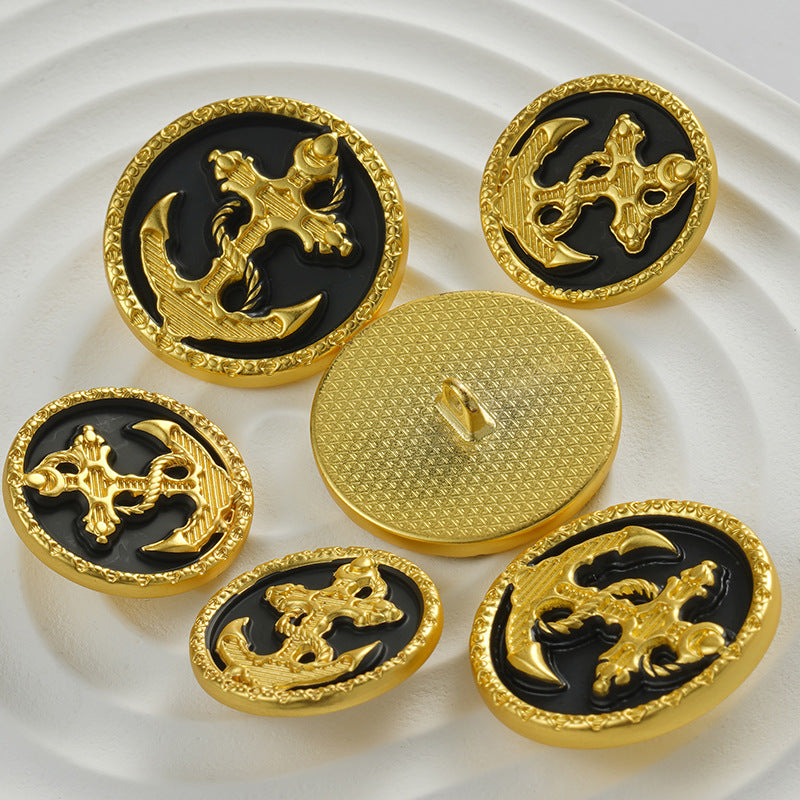 Golden alloy buttons with textured backs and black fronts featuring raised gold anchor motif