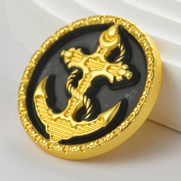 Golden round hand-sewing button, black center with gold anchor relief and 4 feet
