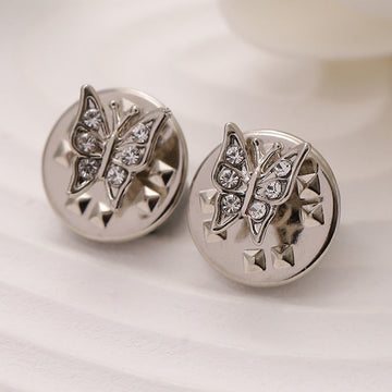 Silver metal butterfly brooches with clear rhinestone details on round discs