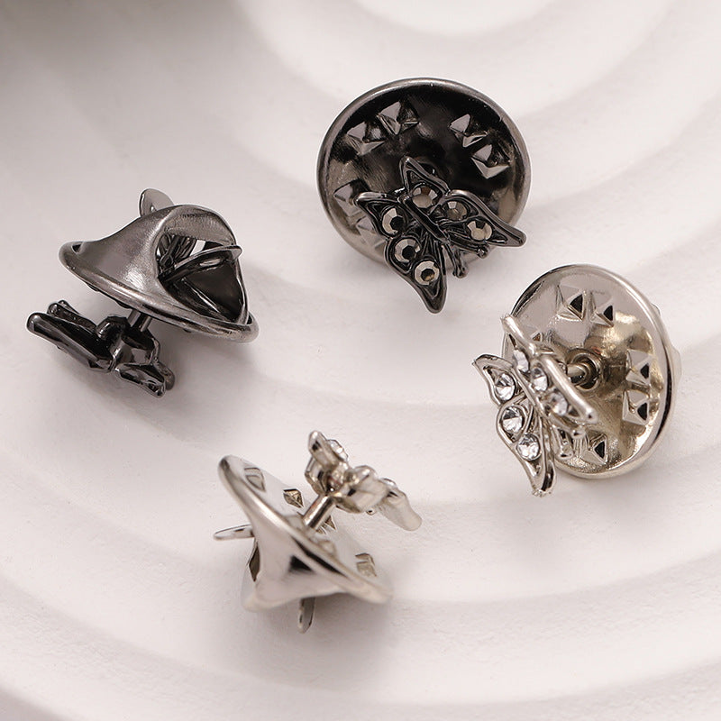 Set of silver butterfly shirt brooches with rhinestone and cutout star accents, 2 shown