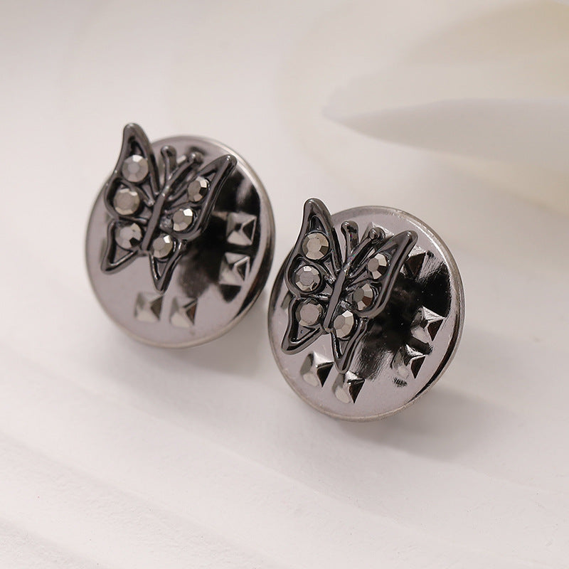 Silver metal butterfly brooches with clear stones and starburst cutouts, two-pack view