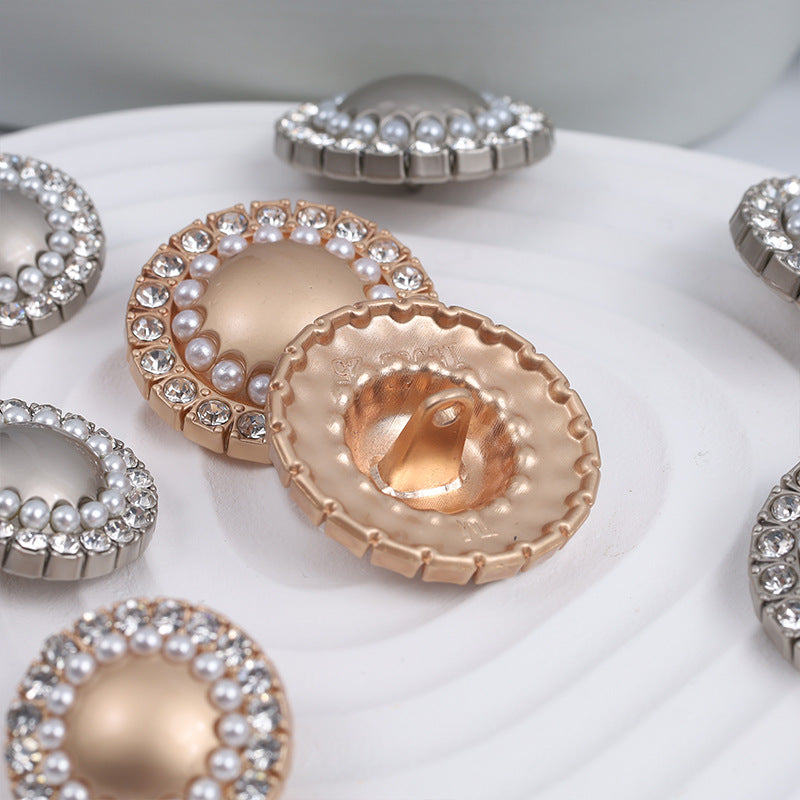 Gold-tone round pearl rhinestone button with metal prong back shown