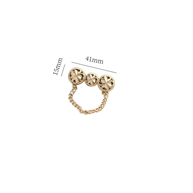Gold-tone chain brooch pin with three four-leaf clover discs; 41mm x 15mm