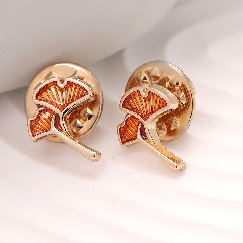 Rose-gold ginkgo leaf shirt pin brooch, orange enamel leaf detail, stud clasp.
