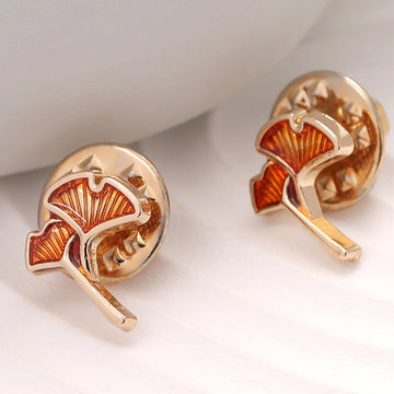 Rose-gold ginkgo leaf shirt pin brooch with orange enamel, butterfly clasp visible.