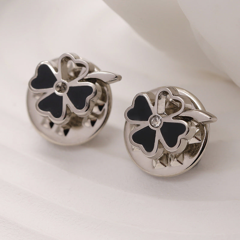Silver four-leaf flower metal brooch with black enamel petals and clear rhinestone