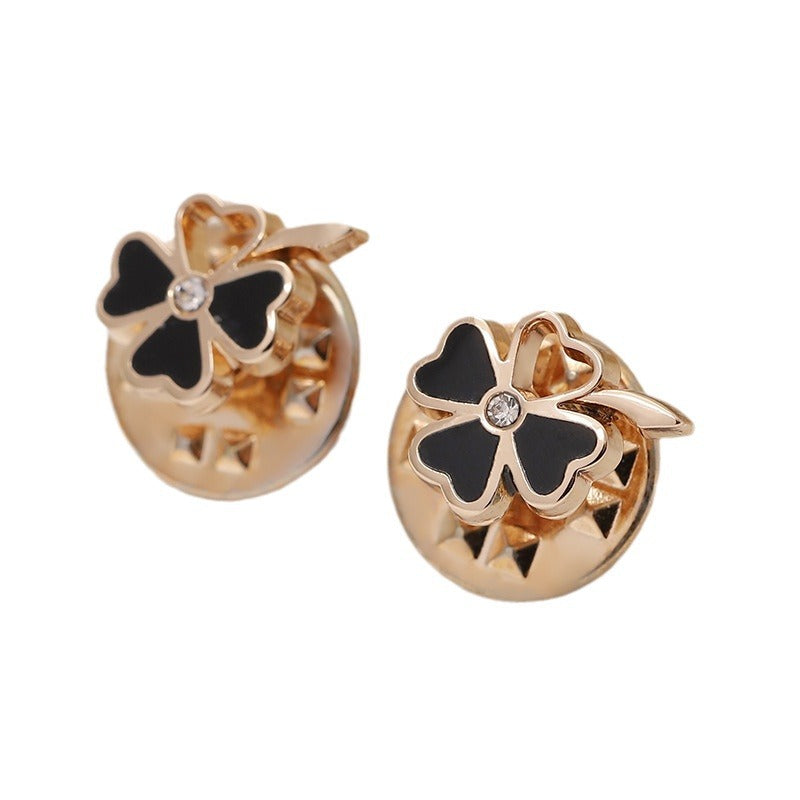 Gold four-leaf flower metal brooches with black enamel petals and clear rhinestone