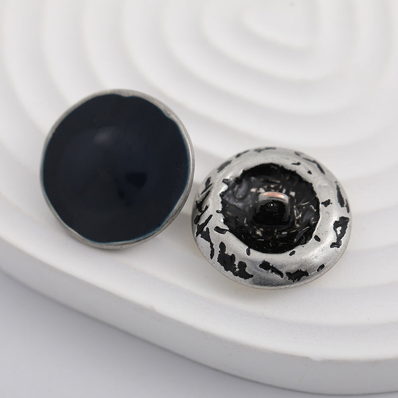 Pair of 23mm round buttons: black lacquer face, antique silver back with shank