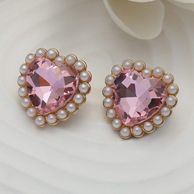 Two pink heart crystal buttons with pearl ring border and gold metal rim